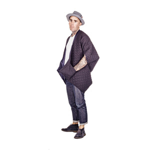 Man wearing The Costume Room The Gar coat kimono style black linen quilted coat with navy collar