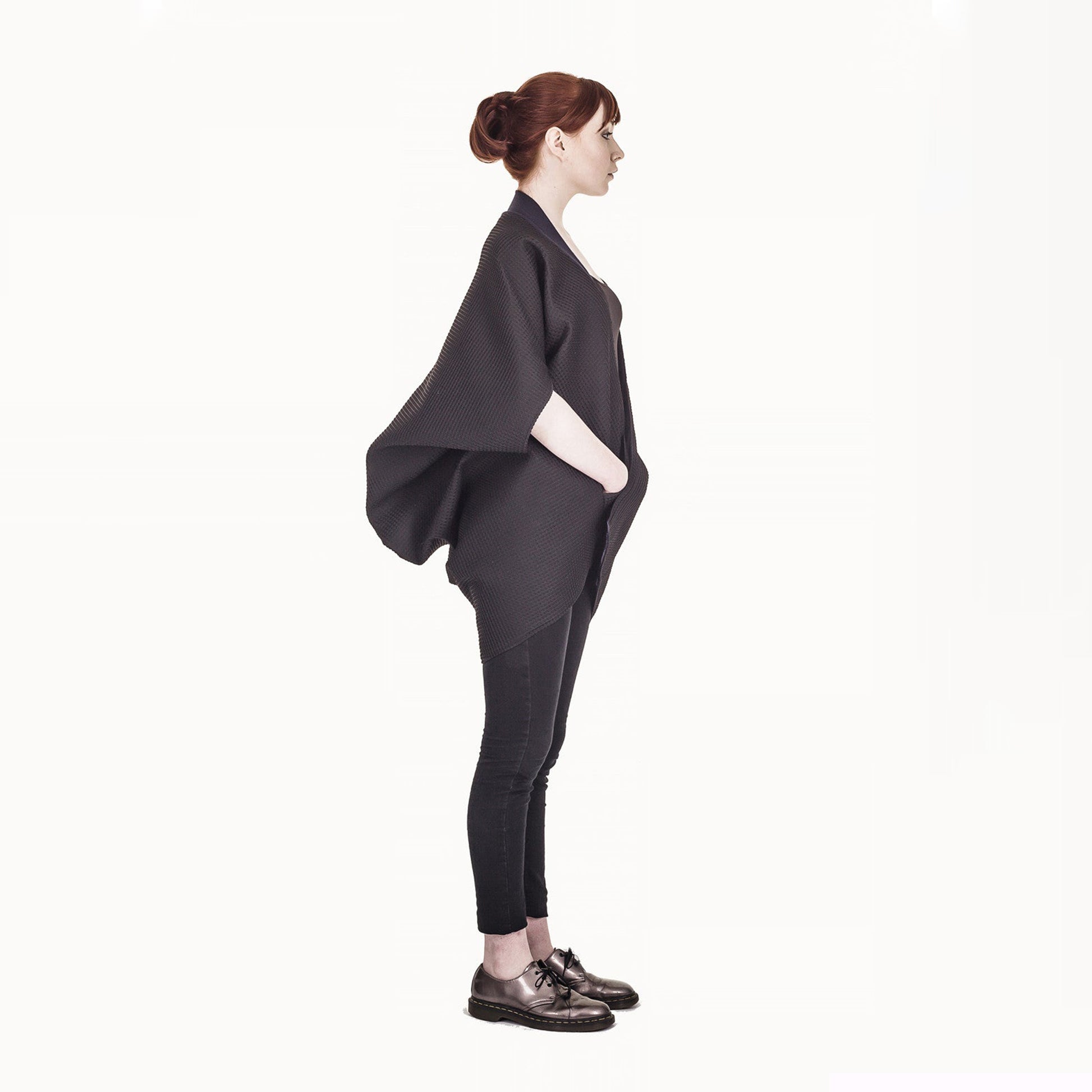 Woman wearing The Costume Room The Iris kimono style black waffle weave coat with navy blue collar