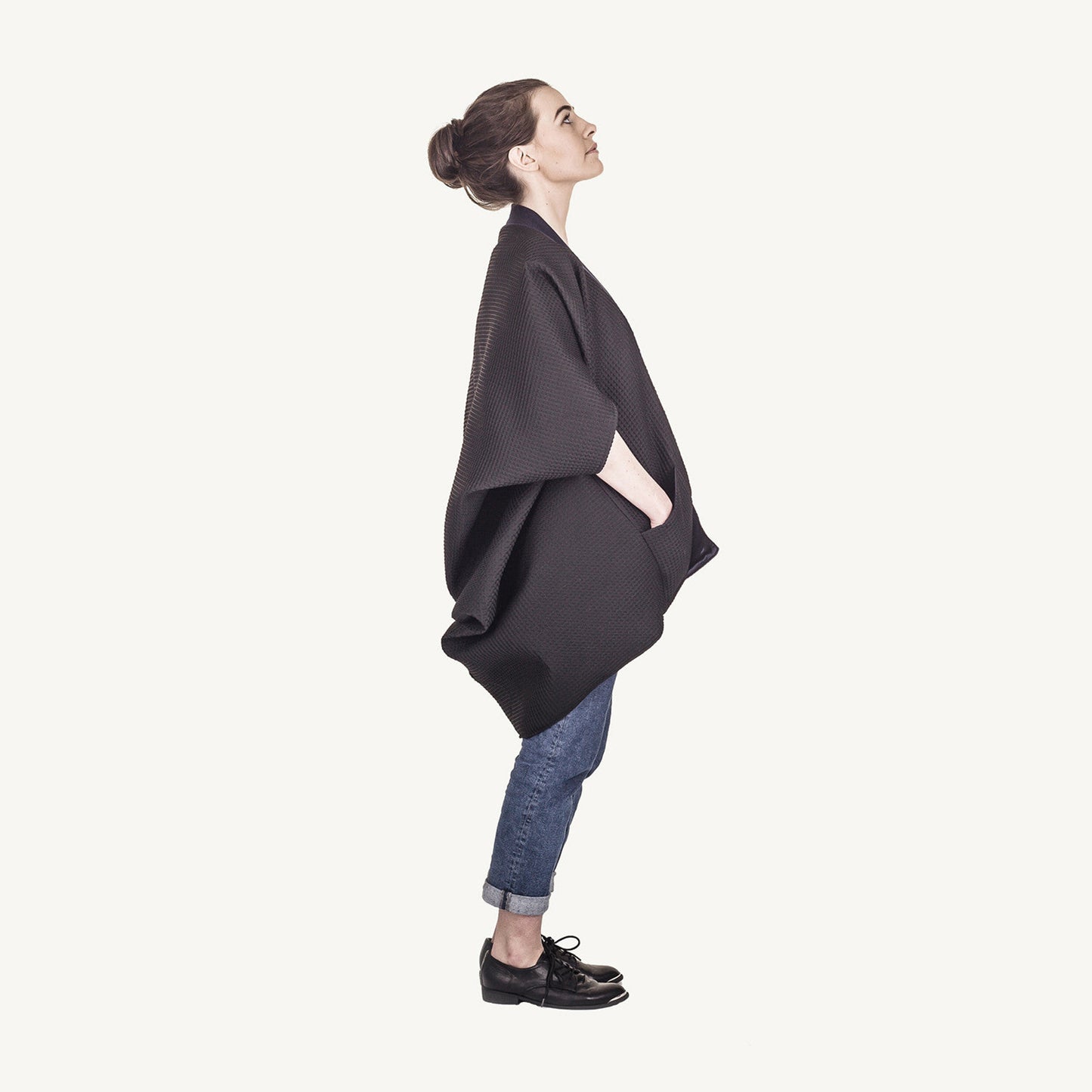 Woman wearing The Costume Room The Iris kimono style black waffle weave coat with navy blue collar