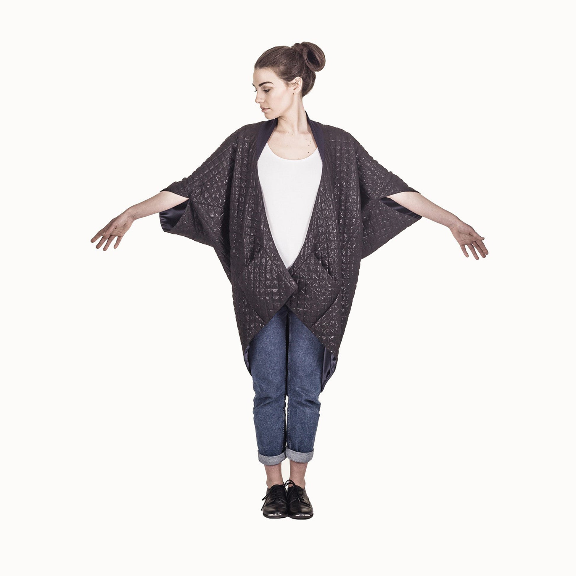 Woman wearing The Costume Room The Shell kimono style black shiny coat with navy blue collar
