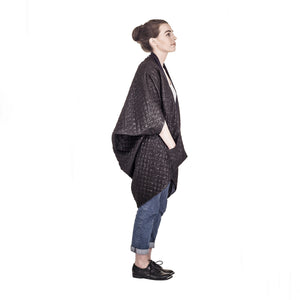 Woman wearing The Costume Room The Shell kimono style black shiny coat with navy blue collar